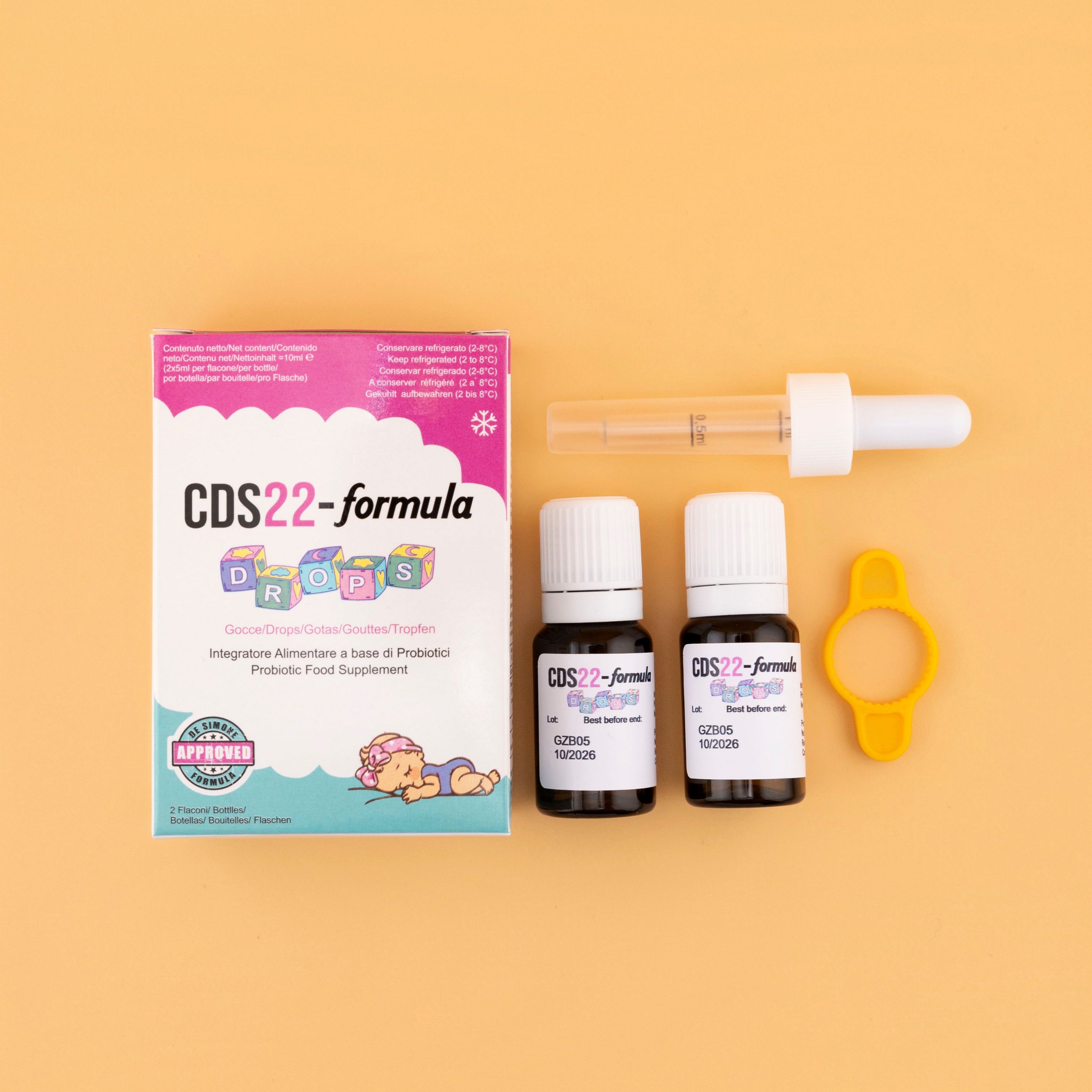 CDS22-formula packaging with two bottles and a dropper on a beige background
